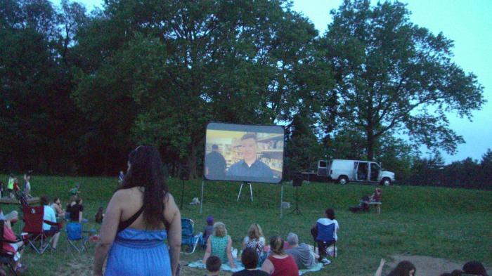 Merchants Association Vice President Shawn Nealis on the Big Screen at Movie Night